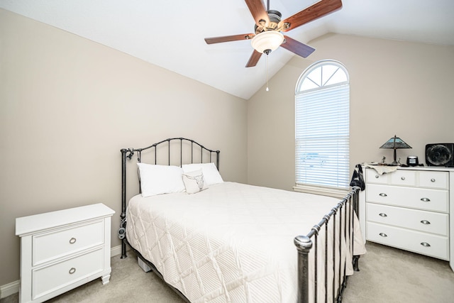 bedroom featuring lofted ceiling, multiple windows, light carpet, and ceiling fan