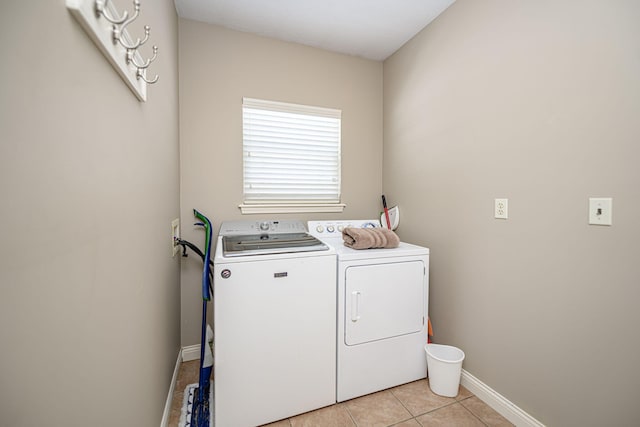 washroom featuring light tile patterned floors and washer and clothes dryer