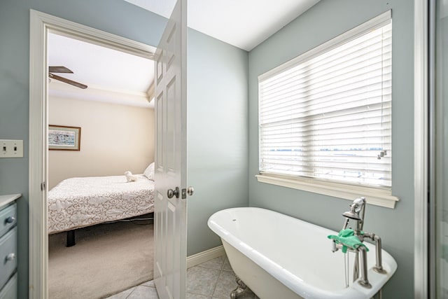 bathroom with plenty of natural light, a bath, vanity, and tile patterned flooring