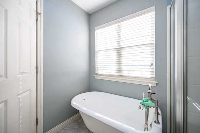 bathroom featuring tile patterned floors and a bathing tub