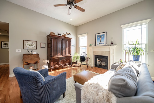 living room with light hardwood / wood-style flooring and ceiling fan