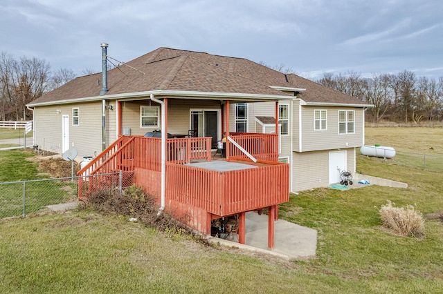 back of house with a wooden deck and a yard