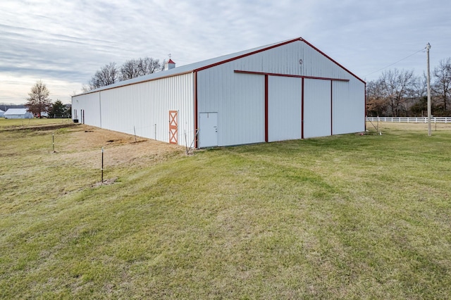 view of outbuilding featuring a yard