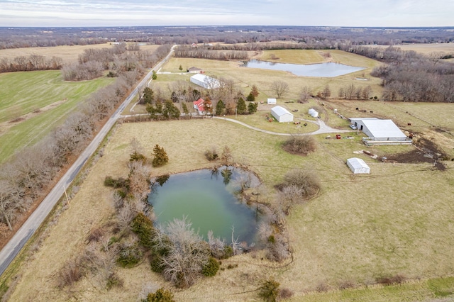 birds eye view of property with a water view and a rural view