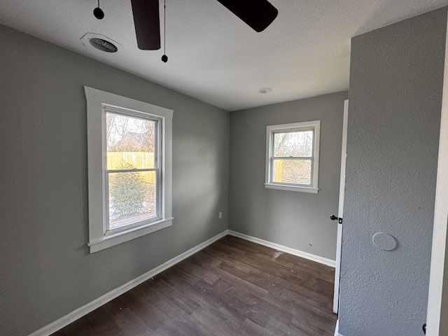 empty room with wood-type flooring, ceiling fan, and plenty of natural light