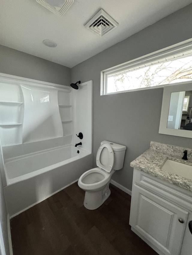 full bathroom with hardwood / wood-style flooring, shower / bathtub combination, vanity, and toilet