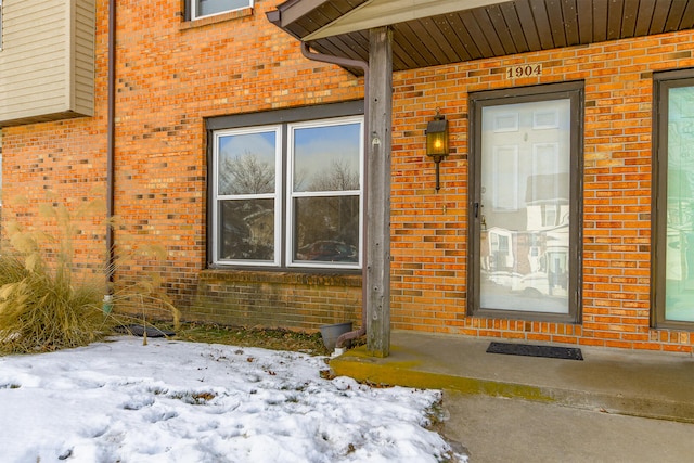 view of snow covered property entrance