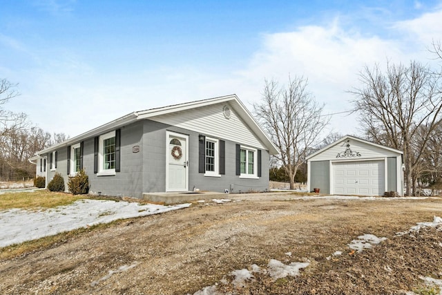 single story home featuring an outbuilding and a garage