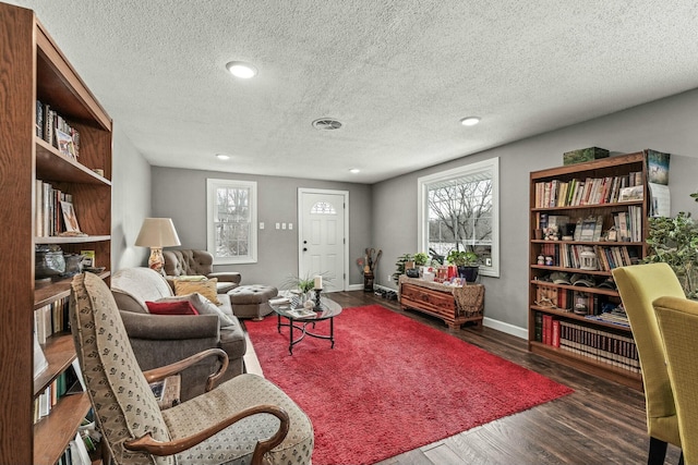 sitting room featuring a textured ceiling and dark hardwood / wood-style flooring