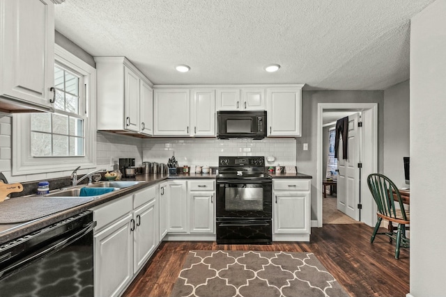 kitchen featuring sink, black appliances, dark hardwood / wood-style floors, and white cabinets