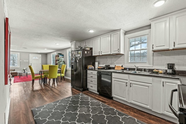 kitchen featuring white cabinets, dark hardwood / wood-style flooring, sink, and black appliances