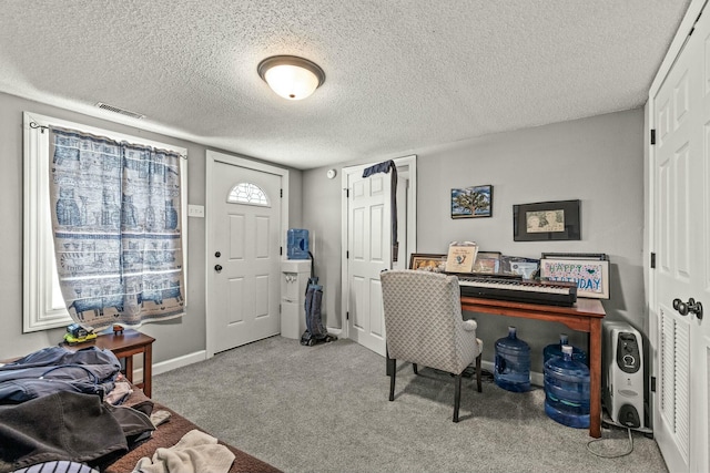 carpeted home office with a textured ceiling