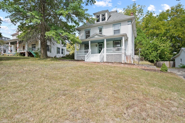 view of front of property featuring a front yard and covered porch