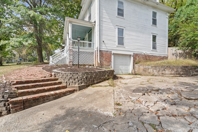 back of property with a garage