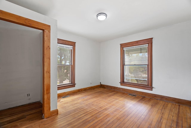 spare room featuring wood-type flooring