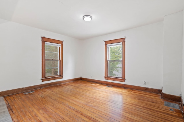 spare room featuring wood-type flooring