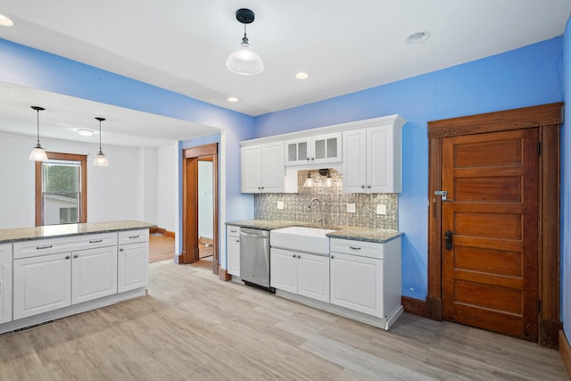 kitchen featuring white cabinetry, hanging light fixtures, light hardwood / wood-style flooring, and dishwasher