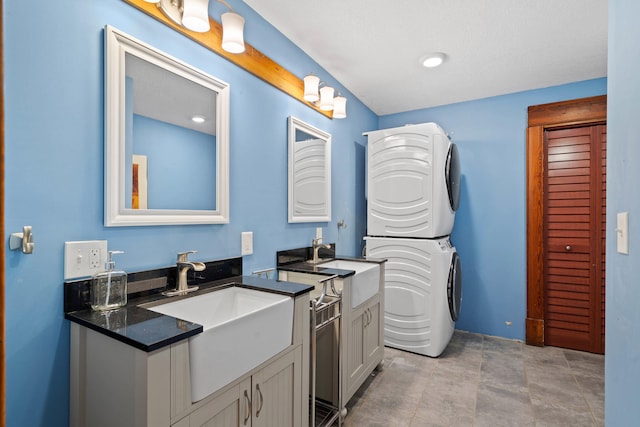 bathroom with stacked washer and dryer and vanity