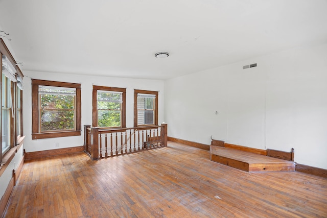 unfurnished room featuring hardwood / wood-style floors