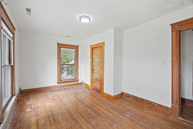 unfurnished bedroom with wood-type flooring and a closet