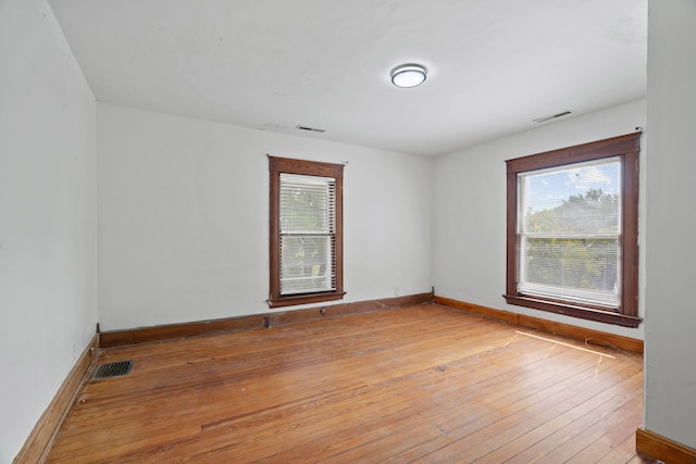 empty room with hardwood / wood-style floors