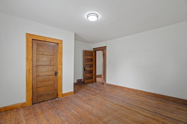 spare room featuring wood-type flooring