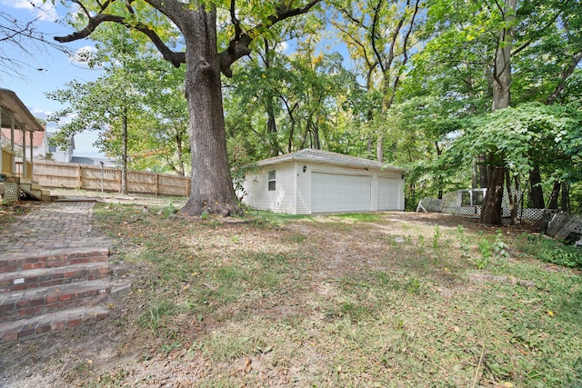 view of yard with a garage and an outdoor structure