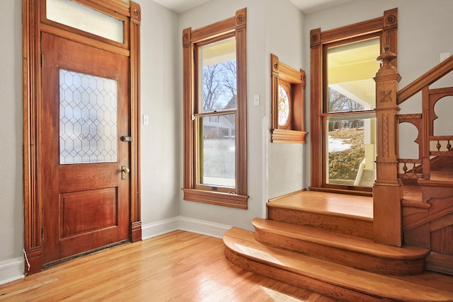 entryway with a healthy amount of sunlight and light hardwood / wood-style floors