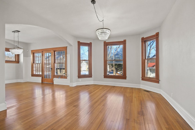 interior space with light hardwood / wood-style flooring and a notable chandelier