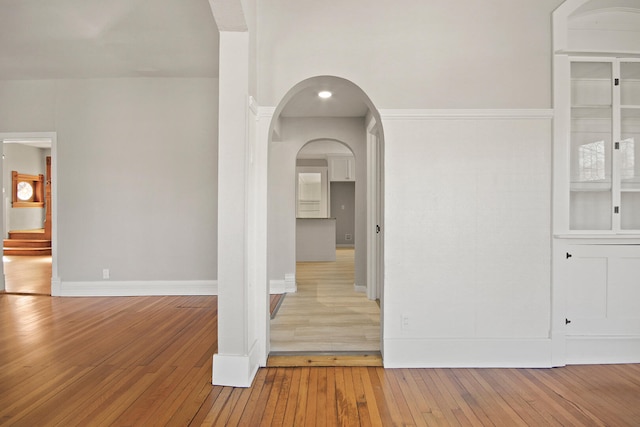 corridor with light hardwood / wood-style floors