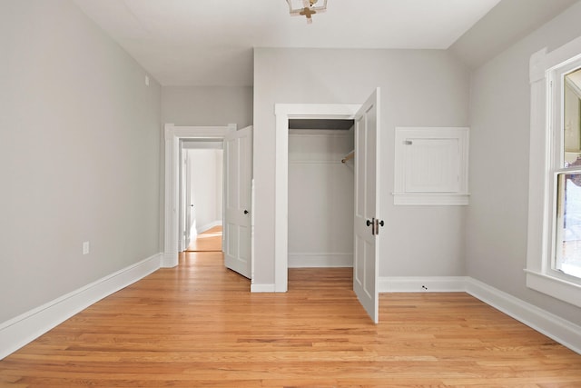 unfurnished bedroom featuring light hardwood / wood-style floors and a closet