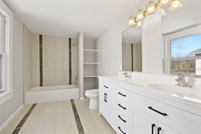 full bathroom with tile patterned floors, vanity, toilet, and tiled shower / bath combo