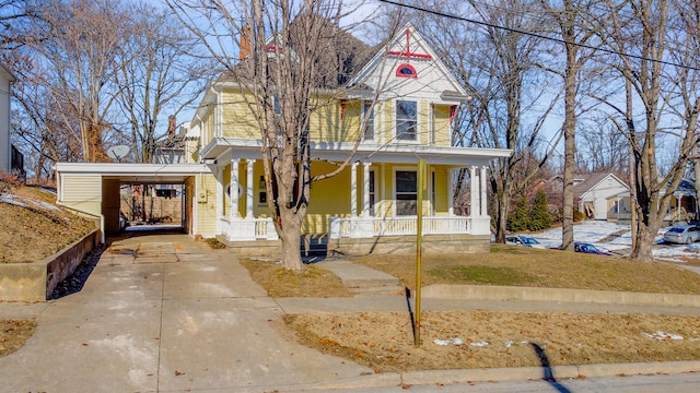 victorian-style house with a carport and covered porch