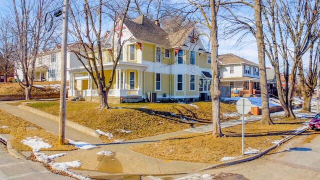 victorian house featuring central air condition unit