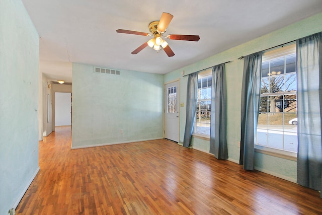 empty room featuring wood-type flooring and ceiling fan