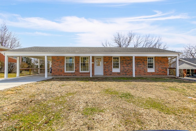 ranch-style home with a carport, concrete driveway, and brick siding