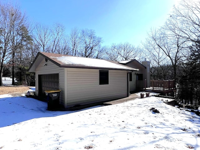 exterior space with a wooden deck and a garage