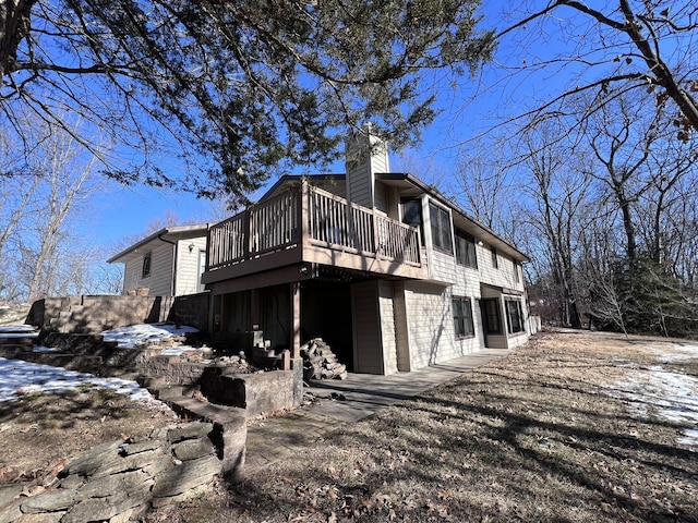 view of snowy exterior with a deck