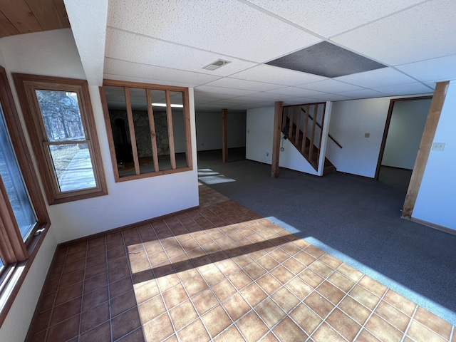 basement with a paneled ceiling