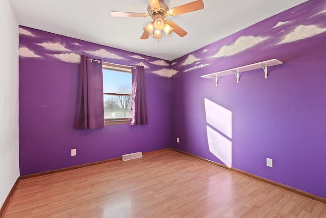 spare room featuring ceiling fan and light wood-type flooring