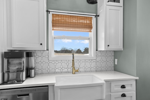 kitchen with white cabinetry, dishwasher, sink, and backsplash