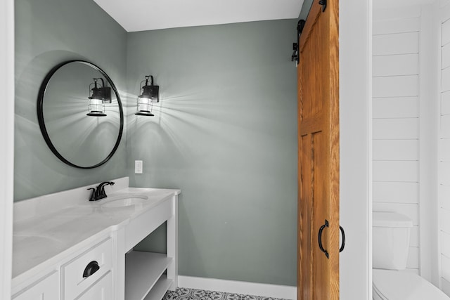 bathroom featuring vanity and toilet