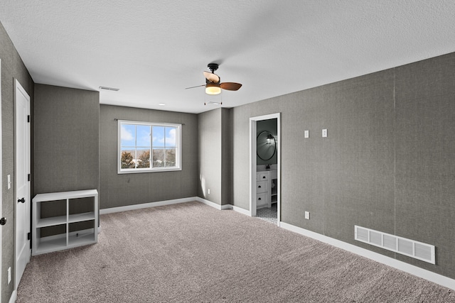 unfurnished bedroom with a textured ceiling, ceiling fan, and carpet flooring