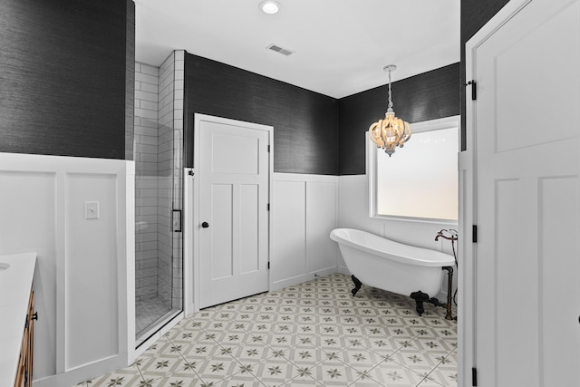 bathroom with shower with separate bathtub and a notable chandelier