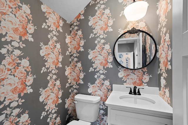 bathroom with vanity, a textured ceiling, and toilet