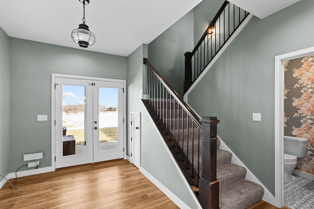 entrance foyer with light wood-type flooring and french doors