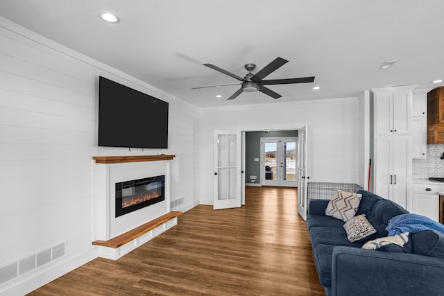 living room with french doors, ceiling fan, and dark hardwood / wood-style floors