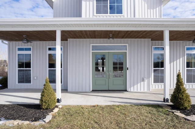 property entrance with a lawn, french doors, and ceiling fan