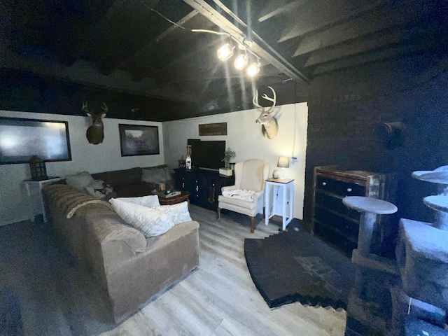 living room featuring beam ceiling and wood-type flooring