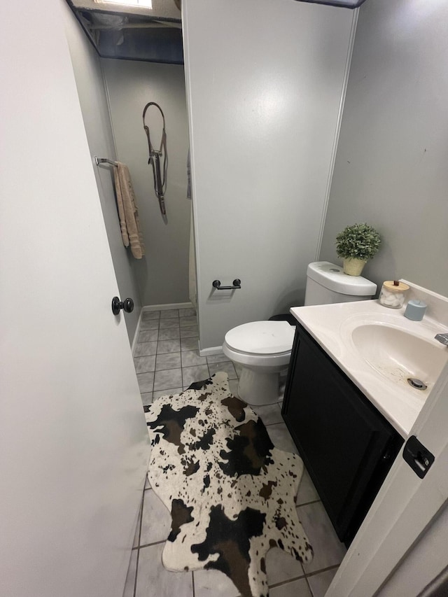 bathroom with vanity, tile patterned floors, and toilet